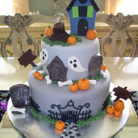 Haunted Halloween Cake Two tier fondant covered cake with fondant and chocolate decorations.