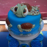 Sea Turtle Cupcake Tower Fondant covered cake with MM fondant decorations. Cupcakes frosted in buttercream with chocolate molded turtle decorations.