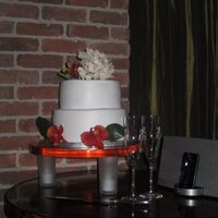 Two Tier/butter Cream Frosting Two tier cake with Hydrangea and orange flowers.