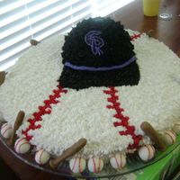 Baseball Cake White cake tinted purple to match team color. BC icing, hat made out of icing. Tried to make the brim of the hat out of black fondant, but...
