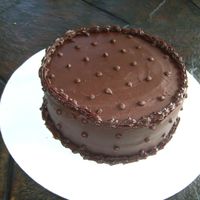 Ganache Cake this was a 6" yellow cake with raspberry filling covered in a semisweet chocolate ganahce. i'm kind of obsessed with this combo...