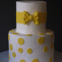 Yellow And White Buttercream iced, 50/50 and gumpaste accents.