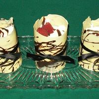 Raspberry Charlottes Devils Food Cake, Butter Cream Icing, Raspberry Vanilla Cream, topped with fresh whipping cream raspberry sauce and fresh raspberries,...