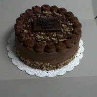 Chocolate Cake I made this for my friend's 28th birthday. The cake is chocolate with a milk chocolate buttercream, on top is heath toffee and pecan...