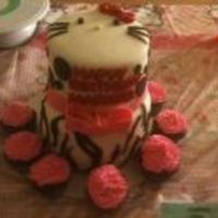 Hello Kitty Multi Patterned Hello kitty face on the topside, polka dots on the top tier with zebra striping on the bottom.. fiancee wanted woodstock snuck in somewhere...