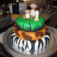 Manny's 1St Birthday - Monkey Theme all fondant deco. w/ choco fudge bottom & top layer with vanilla pudding in the middle. [: pain in the butt to hand cut all deco but...