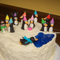 Penguin Party 9" round, buttercream with fondant penguins for my daughter's first birthday. There's even an imposter bunny rabbit "...