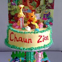 Winnie The Pooh And Friends Mocha cake covered and decorated with marshmallow icing