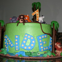 Jungle Theme 1St Birthday Jungle animals made from gumpaste... the cake itself was rainbow colored which was a surprise for the client :)