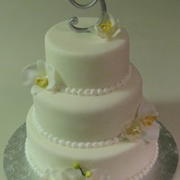 Lemon Orchid Wedding Cake 6", 8", 10" round - Lemon pound with lemon filling.Silk flowers and topper provided by bride. Border piped with royal icing...