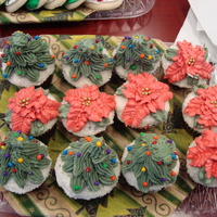 Christmas Tree And Poinsetta Cupcakes chocolate and vanilla cupcakes iced and dipped in sanding sugar, topped with piped tree/poinsetta, had tonnes of fun making these!!!