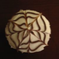 Enchanting Web Yellow cake with white buttercream and chocolate detail.