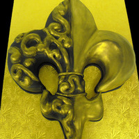 Black And Gold Fleur De Lis The fleur de lis was carved out of a full sheet, decorated with fondant accents and painted with gold luster dust.