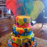 Flower Cake 1st layer - tye dye 2nd layer - orange and pink 3rd layer - green and blue buttercream icing (indydebi recipe) covered in MMF flowers MMF