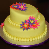 Topsy Turvy Daisey Cake 2- tier topsy turvy cake, covered in MMF with fondant daisy cut outs. This was my final cake for the Wilton Course 4 Class.