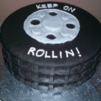 Tire Retirement White cake, chocolate ganache. covered in MMF. I made this for a woman retiring from goodyear.