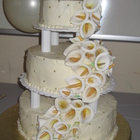 My First Wedding Cake :) ivory and gold, with calla lillies and gold bouquet of roses on top...has flaws but I'm pretty darned proud of it still :) THANK you...