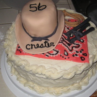 Western Cake white cake with cream cheese frosting, everything else on top is fondant (hat, hanky, branding irons, rope