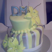 Yellow Oriental Lillies Wedding Cake Yellow Oriental Lillies Topsy Turvy Wedding Cake.Colour Scheme - Yellow, Silver and White