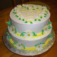 Daisy Wedding Cake 12 inch double layer on bottom and 10 inch double layer on top. Buttercream icing and fondan and gumpaste daisies