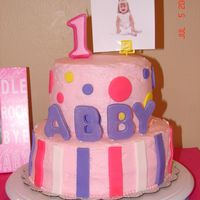 First Birthday Cake Inspired by the birthday theme- Lil' Cupcake. Cream cheese icing with fondant accents. Had planned for a color flow #1 for the top,...