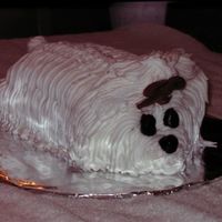 My First Puppy Cake Two layer chocolate cake with chocolate ganache and fresh strawberry filling and buttercream frosting.