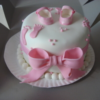 Baby Shower Test Cake Round WASC with raspberry spead filing, buttercream with fondant. First attempt at bow, footprints, and booties. This was a sample I gave to a...