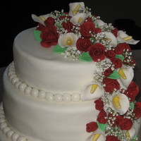 Kelly's Wedding Cake This is a stacked 12", 10" & 8" round cakes. The roses and calla lilies are all made out of MMF and it was my first time...