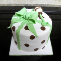 Baby Shower Cake With Rattle This cake & cupcakes were made for a baby shower. The giftbox cake is topped with a bow and a rattle made out of modeling chocolate.