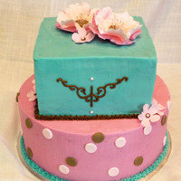 Simple & Classy I wanted this cake to be simple and elegant. I piped the design on the sides of the top square tier and made gumpaste flowers.