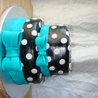 Jessica's Birthday Cake Black with white polka dots and teal bow... was made to match the birthday girl's dress!