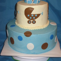 Blue & Brown Baby Cake Buttercream icing with fondant accents and booties on top.