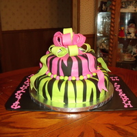 Hot Pink And Lime Green Zebra Striped Cake 12 in. bottom, 8 in. top with satin ice fondant covering and decorations. Will do bow differently next time but the customer absolutely...