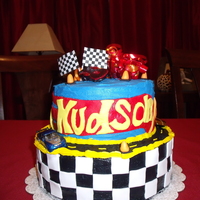 Hot Wheels Birthday Cake Two tier Hot Wheels cake with buttercream frosting and fondant decorations. Had a little trouble with the red flame getting black icing on...