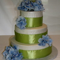First Wedding Cake My first wedding cake! 12", 9" and 6" tiers. Buttercream icing. Silk flowers and satin ribbon.