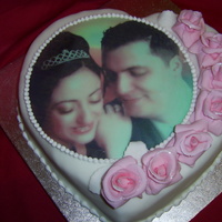 Valentines And Anniversary Cake With Sugar Roses And Edible Image Heart shaped chocolate cake with Ganache underneath fondant. Roses made of half sugar paste half flower paste/gum paste. royal icing piped...