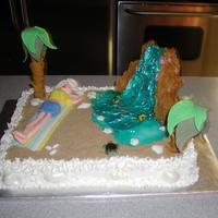 A Day At The Beach Pink Champagne cake with Champagne butter cream icing. Sun bather is 50/50 fondant and gum paste. Palm Trees are pretzels w/ 50/50 fondant...