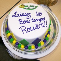 Fat Tuesday Cake Devils food with bavarian cream filling covered with milk chocolate ganache under MMF. Had some trouble with the writing so it looks kinda...