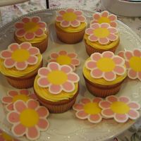 Baby Shower Flower Cupcakes I made these for a friend's baby shower. The flowers are made out of Wilton's candy melts. It was very time consuming but they...
