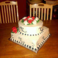 Black, White And Red Wedding Theme Bottom tier is butter cake with choc ganache; top tier is cocoa cake with choc raspberry ganache; frosting is BC; roses are fondant/GP;...