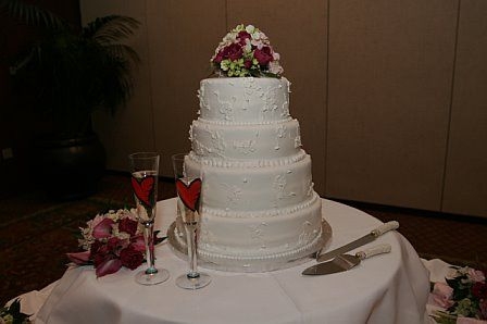 My 4Th Wedding Cake This was my fourth wedding cake. Iced in fondant with fondant and buttercream flowers. It was a pound cake with white chocolate rasberry...