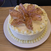 Cake Final For Culinary School French mousseline buttercream, raspberry pistachio lace cookies, lemon pistachio spongecake with a raspberry mousse.