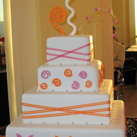 Orange And Pink Wedding Cake This was for my cousin's wedding. She wanted something fun and her colors were pink and orange. She absolutely loved it!