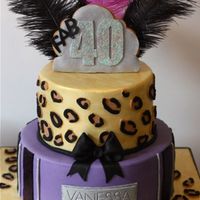Leopard Print Party Cake 2 tiered chocolate mud with chocolate raspberry ganache filling.Cookie topper.