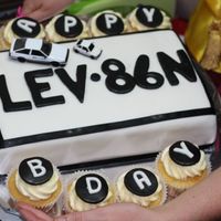 Licence Plate Cake My first ever fondant covered cake.Made for a friends 30th. Its a licence plate cake with happy birthday cupcakes.