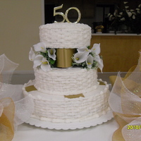 50Th Anniversary Cake 3 tier 50th Anniversary cake with basketweave, gold ribbon, and calla lilies