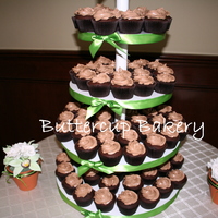 Wedding Cupcake Tower chocolate cake with dark chocolate ganache filling topped with chocolate buttercream.Sugar flowers on either side of the cake