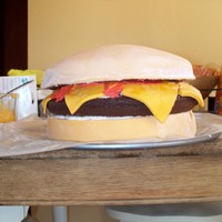 Cheeseburger Birthday Cake This is a 3 layer b-day cake. The top and bottom layer are covered in MMF. The center layer is a chocolate cake with red & yellow icing...