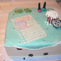 Sleepover My kids made this cake. All the decorations are made from chocolate, and the paper is fondant, and drawn on with edible markers.