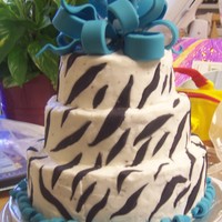 Blue Zebra Cake Chocolate cake with bc frosting, fondant stripes, bow and curlicues.